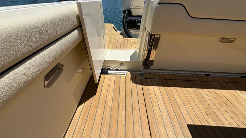Sea Dragon Yacht Photos Pics 2023 Chris-Craft Calypso 35 boat deck with open door, showcasing teak flooring.