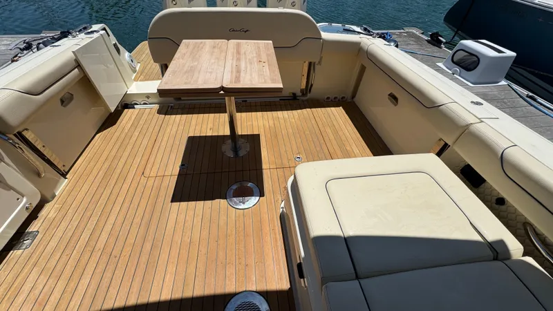 Sea Dragon Yacht Photos Pics 2023 Chris-Craft Calypso 35 boat interior with wooden deck and seating area.