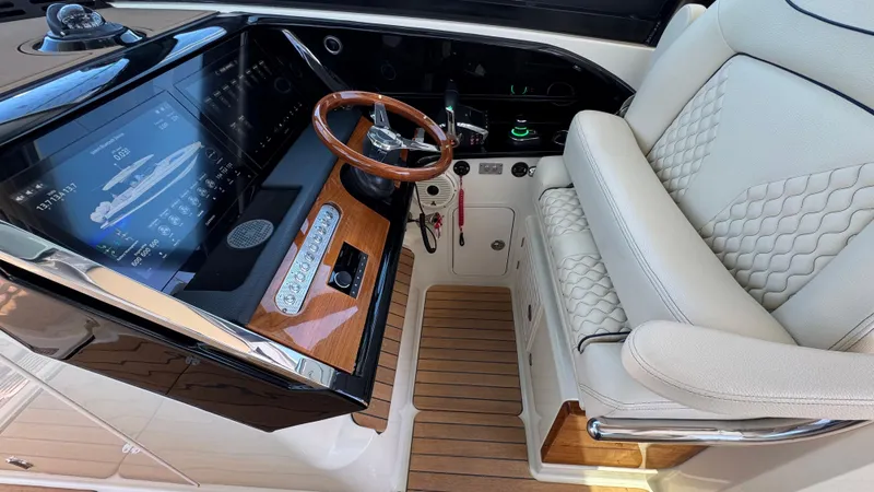 Sea Dragon Yacht Photos Pics 2023 Chris-Craft Calypso 35 helm with luxury seating and advanced navigation display.