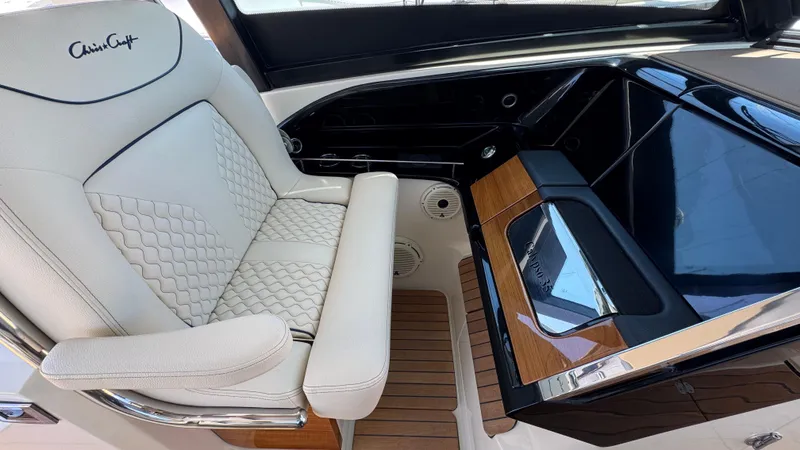 Sea Dragon Yacht Photos Pics Luxurious interior of 2023 Chris-Craft Calypso 35 with elegant seating and sleek dashboard design.