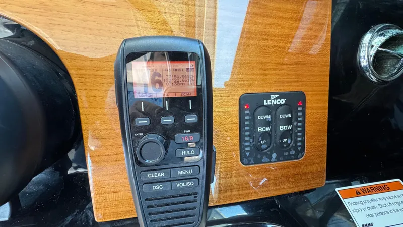 Sea Dragon Yacht Photos Pics Control panel of 2023 Chris-Craft Calypso 35 with radio and Lenco trim tab switches.