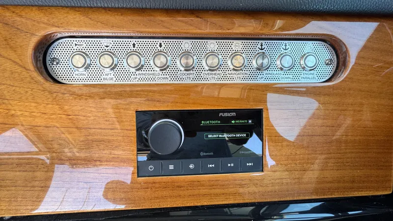 Sea Dragon Yacht Photos Pics Control panel of 2023 Chris-Craft Calypso 35 with buttons and Bluetooth audio system.