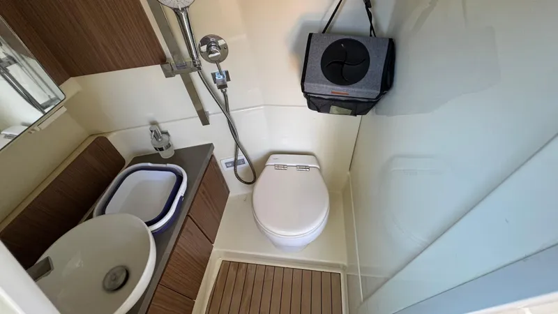 Sea Dragon Yacht Photos Pics 2023 Chris-Craft Calypso 35 bathroom with modern fixtures and wooden accents.