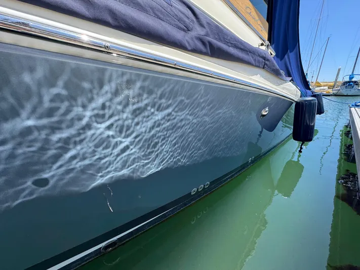 Sea Dragon Yacht Photos Pics 2023 Chris-Craft Calypso 35 boat reflecting water patterns in a marina.