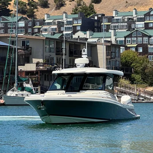 Sea Dragon Yacht Photos Pics 2023 Chris-Craft Calypso 35 boat cruising near waterfront homes.