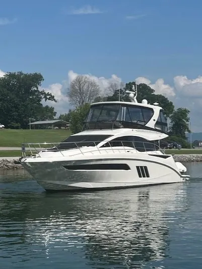 Yonder Star Yacht Photos Pics 2016 Sea Ray 510 Fly yacht on calm water, surrounded by trees and blue sky.