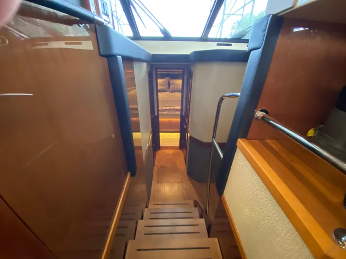Yonder Star Yacht Photos Pics Interior view of 2016 Sea Ray 510 Fly yacht, featuring wooden stairs and modern design.