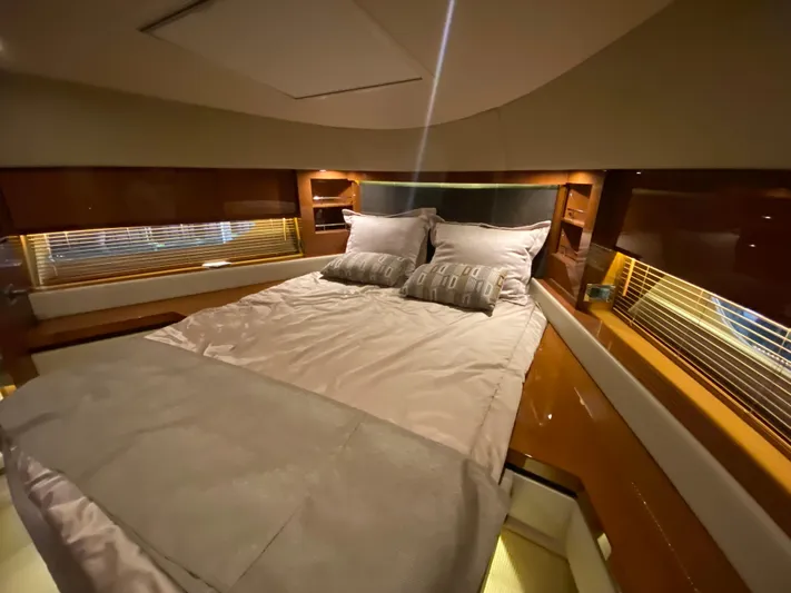 Yonder Star Yacht Photos Pics Luxurious bedroom interior of 2016 Sea Ray 510 Fly yacht with elegant bedding and wood finishes.