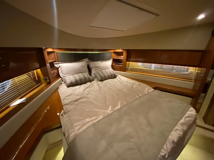 Yonder Star Yacht Photos Pics Luxurious bedroom interior of 2016 Sea Ray 510 Fly yacht with elegant bedding and wood accents.