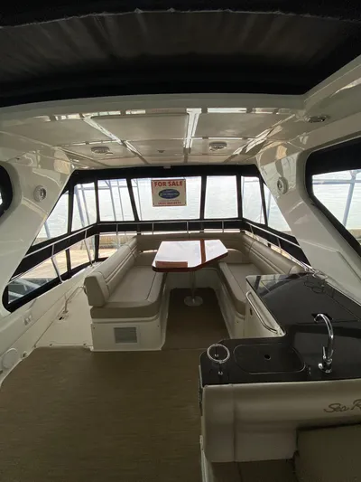 Yonder Star Yacht Photos Pics Interior of 2016 Sea Ray 510 Fly yacht with seating and kitchenette, for sale sign visible.