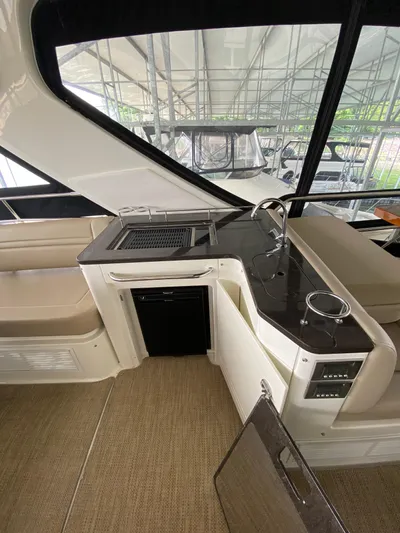 Yonder Star Yacht Photos Pics Interior of 2016 Sea Ray 510 Fly yacht with kitchenette and seating area.
