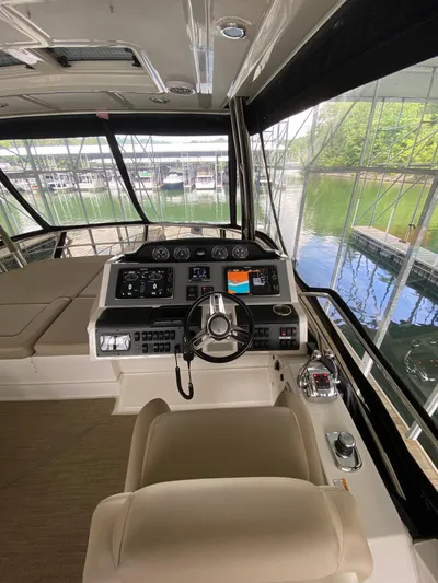 Yonder Star Yacht Photos Pics Interior view of 2016 Sea Ray 510 Fly yacht cockpit with steering wheel and navigation controls.
