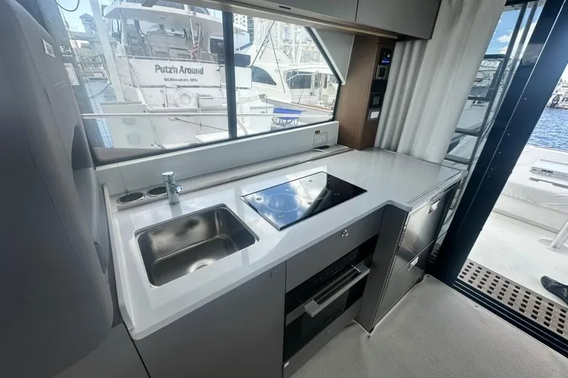  Yacht Photos Pics Modern kitchen in 2025 Beneteau Antares 12 yacht with sleek design and appliances.