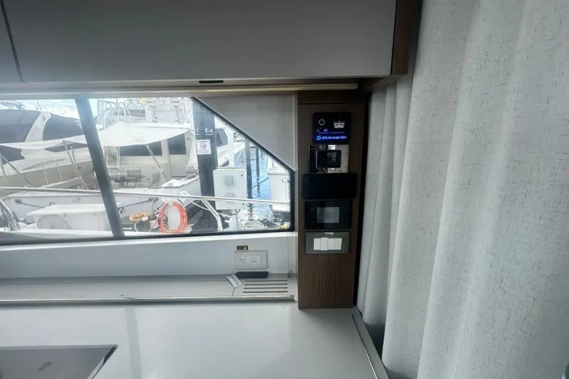  Yacht Photos Pics Interior view of 2025 Beneteau Antares 12 yacht, showcasing modern control panel and window.