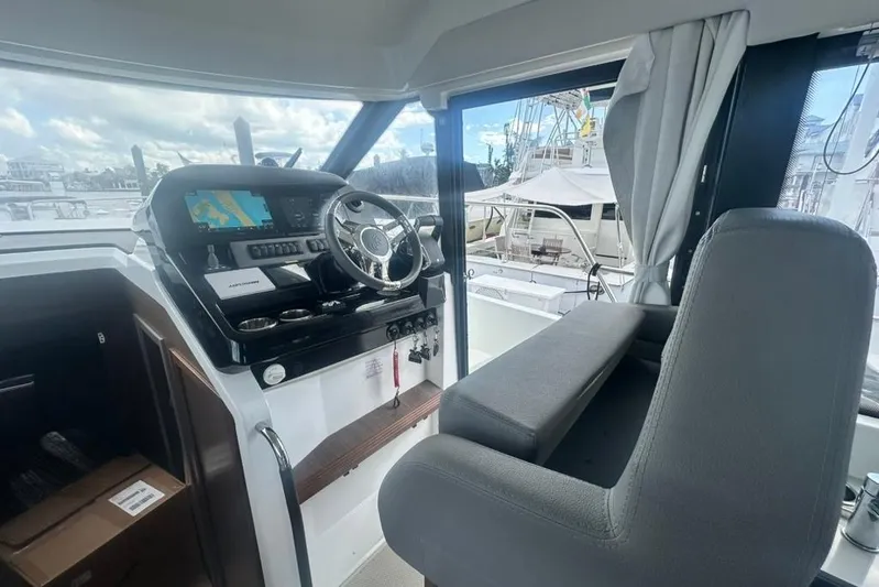  Yacht Photos Pics 2025 Beneteau Antares 12 helm station with modern navigation equipment and comfortable seating.