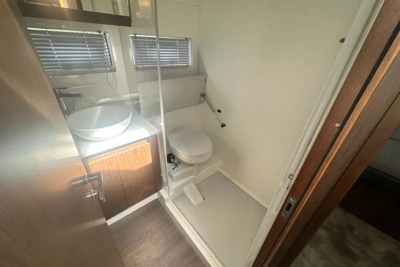  Yacht Photos Pics Bathroom interior of 2025 Beneteau Antares 12 yacht with modern fixtures.