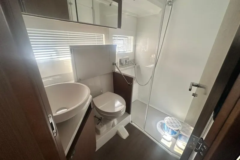  Yacht Photos Pics Modern bathroom in 2025 Beneteau Antares 12 yacht with shower and sink.