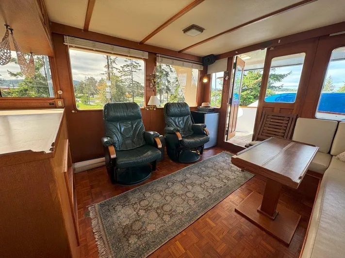  Yacht Photos Pics Interior of 1980 Ocean Alexander 50 MK1 yacht with leather chairs and wooden table.