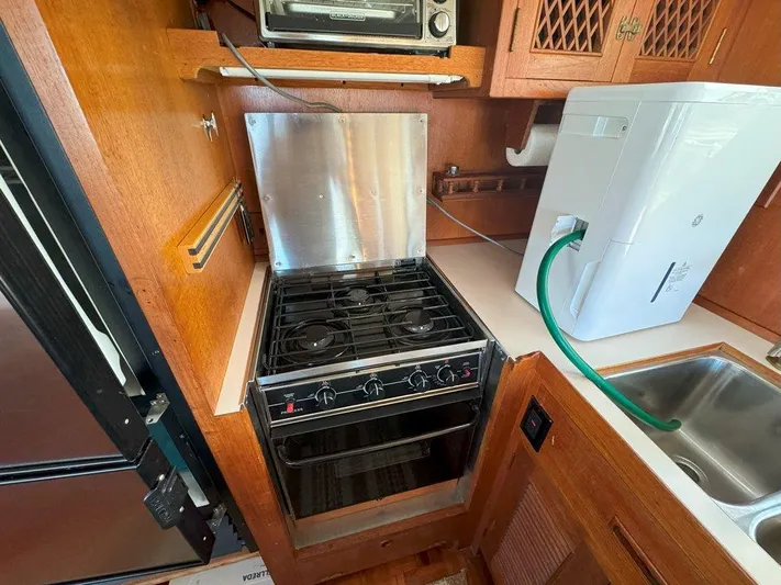  Yacht Photos Pics Galley kitchen in 1980 Ocean Alexander 50 MK1 yacht with stove and sink.