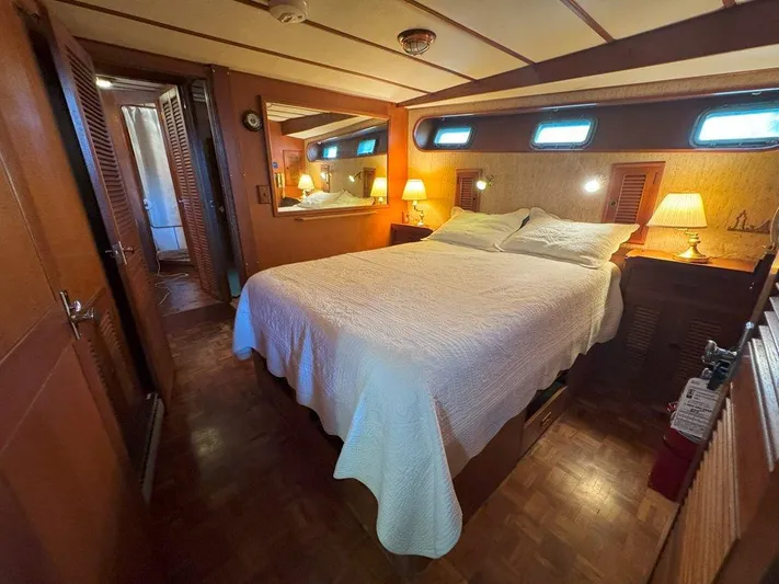 Yacht Photos Pics Cozy bedroom in 1980 Ocean Alexander 50 MK1 yacht with wood paneling and ambient lighting.