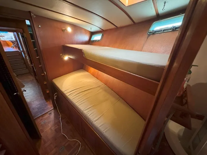 Yacht Photos Pics Interior of 1980 Ocean Alexander 50 MK1 yacht with wooden bunk beds and cozy lighting.