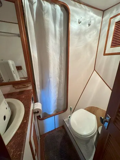  Yacht Photos Pics Ocean Alexander 50 MK1 1980 yacht bathroom with shower, sink, and toilet.