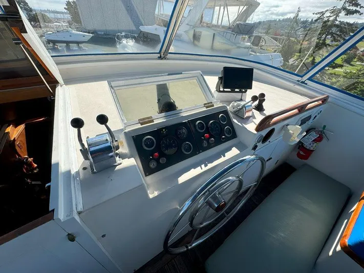  Yacht Photos Pics Helm of 1980 Ocean Alexander 50 MK1 yacht with steering wheel and control panel.