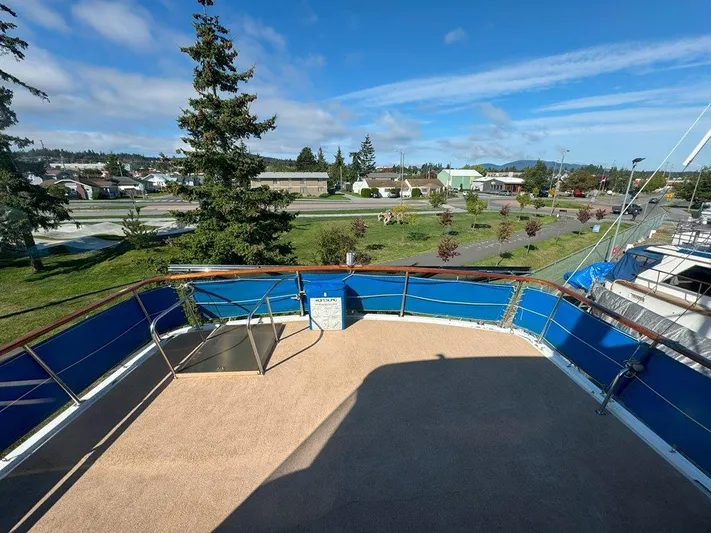  Yacht Photos Pics Ocean Alexander 50 MK1 yacht deck, 1980 model, with blue railings and scenic marina view.