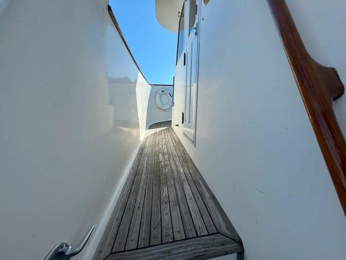  Yacht Photos Pics Narrow deck passage on 1980 Ocean Alexander 50 MK1 yacht with wooden flooring.
