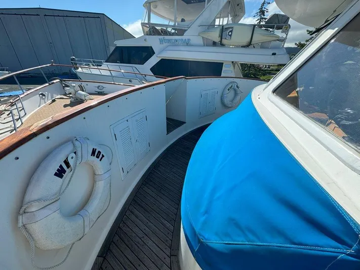  Yacht Photos Pics 1980 Ocean Alexander 50 MK1 yacht deck with blue cover and life rings.
