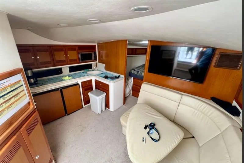  Yacht Photos Pics Interior of 2004 Cabo 40 Express Los Suenos yacht with kitchen and seating area.