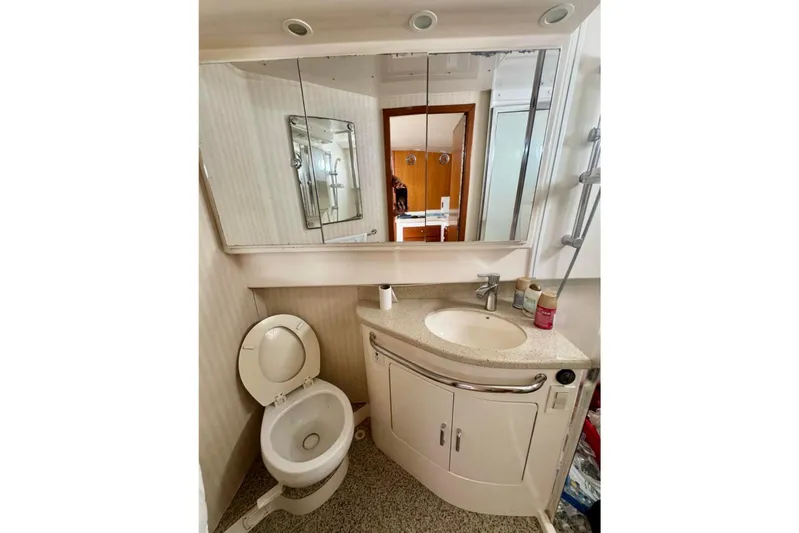  Yacht Photos Pics Bathroom interior of 2004 Cabo 40 Express Los Suenos yacht, featuring sink and toilet.
