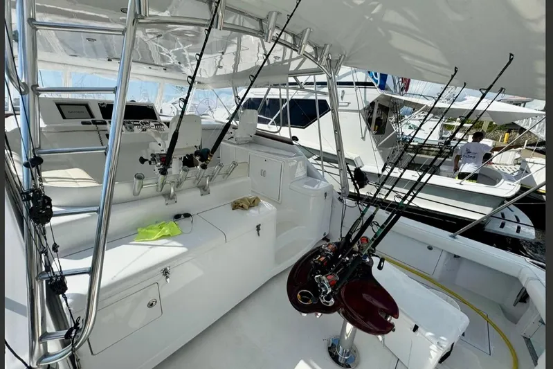  Yacht Photos Pics 2004 Cabo 40 Express Los Suenos yacht interior with fishing rods and equipment.