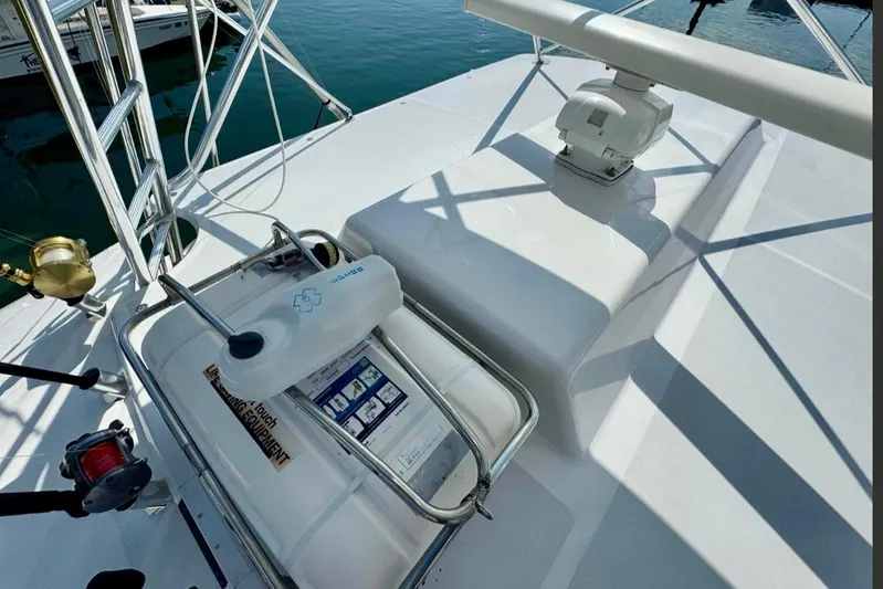  Yacht Photos Pics 2004 Cabo 40 Express Los Suenos boat deck with safety equipment and fishing gear.