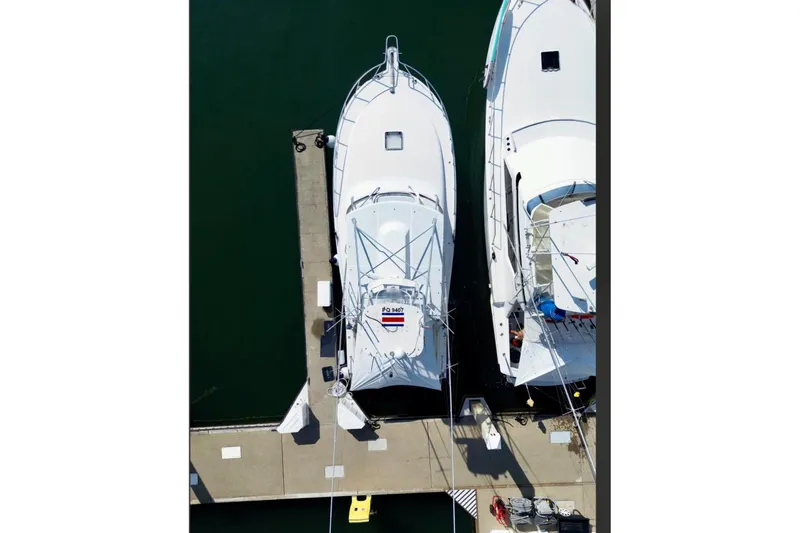  Yacht Photos Pics Aerial view of 2004 Cabo 40 Express Los Suenos docked at marina.