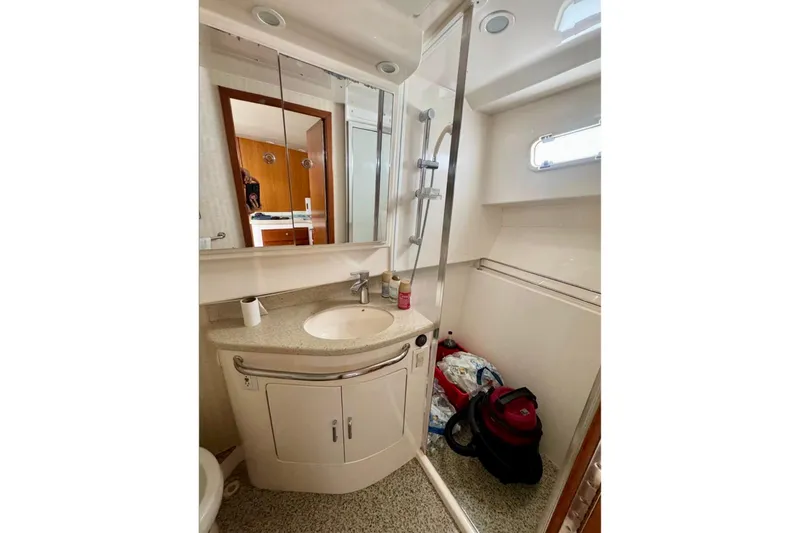  Yacht Photos Pics Bathroom interior of 2004 Cabo 40 Express Los Suenos yacht, featuring sink and shower.
