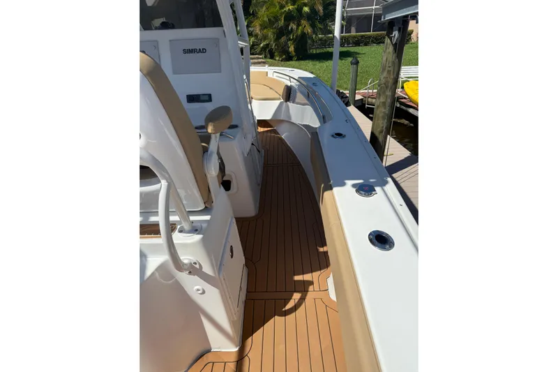  Yacht Photos Pics 2019 Cape Horn 27XS boat interior with teak flooring and Simrad electronics.