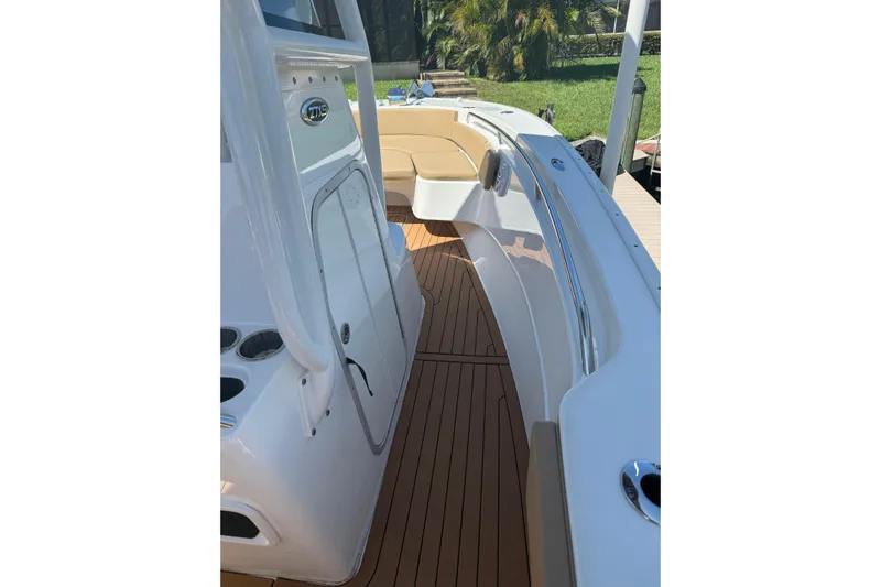  Yacht Photos Pics 2019 Cape Horn 27XS boat interior with teak flooring and seating area.