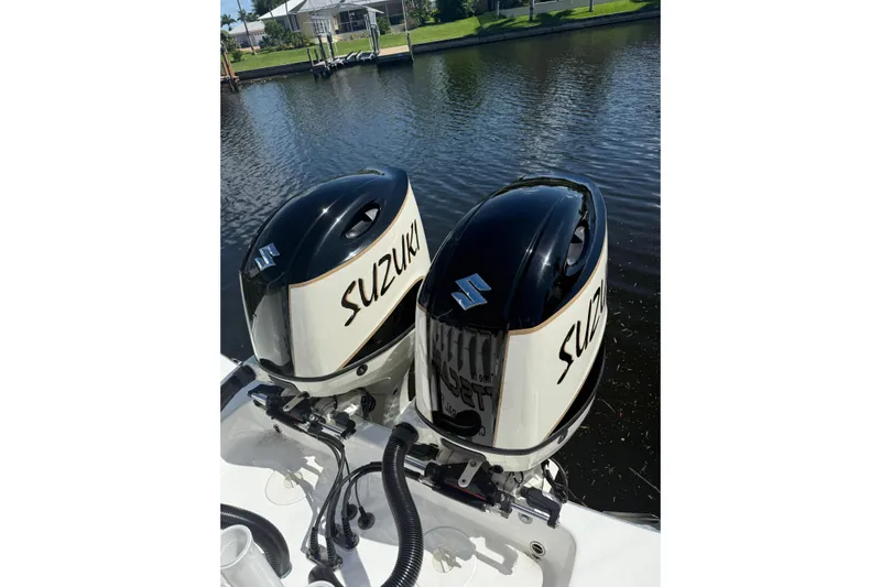  Yacht Photos Pics Twin Suzuki outboard engines on a 2019 Cape Horn 27XS boat by a canal.