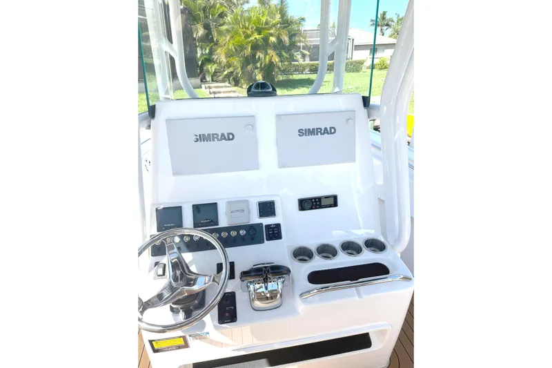  Yacht Photos Pics 2019 Cape Horn 27XS boat console with Simrad displays and steering wheel.