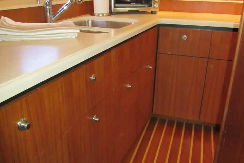Baci Yacht Photos Pics 2006 Tiara Yachts 4300 Sovran galley with wood cabinets and modern sink.