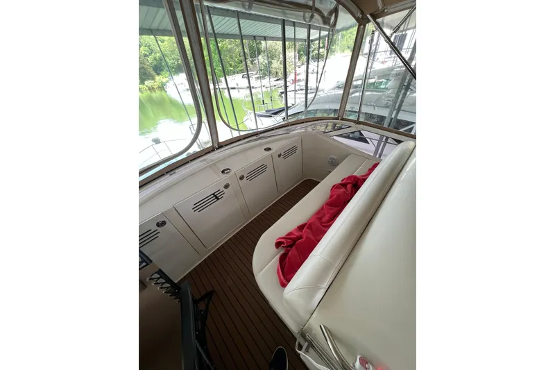  Yacht Photos Pics 2005 Carver 33 Super Sport yacht interior with white seating and red blanket.