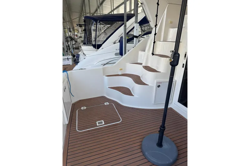  Yacht Photos Pics 2005 Carver 33 Super Sport yacht with elegant wooden deck and curved stairs.