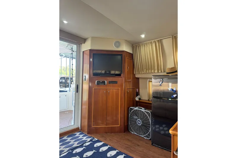  Yacht Photos Pics Interior of 2005 Carver 33 Super Sport yacht with TV, fan, and refrigerator.