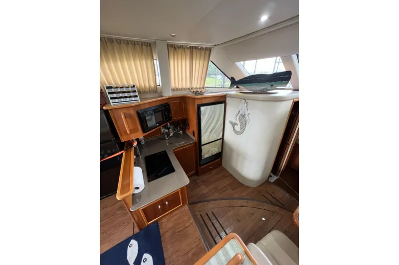  Yacht Photos Pics Interior of 2005 Carver 33 Super Sport yacht with kitchen and mermaid decor.