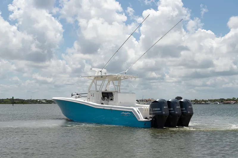  Yacht Photos Pics 2015 Invincible 36 Open Fisherman boat with triple Yamaha engines on water.