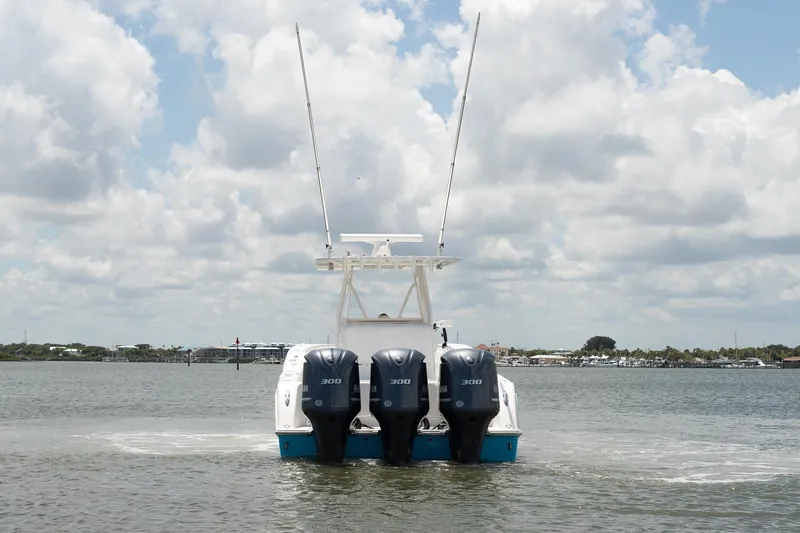  Yacht Photos Pics 2015 Invincible 36 Open Fisherman boat with triple 300 horsepower engines on water.