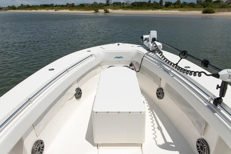  Yacht Photos Pics 2015 Invincible 36 Open Fisherman boat on calm water near a sandy shore.