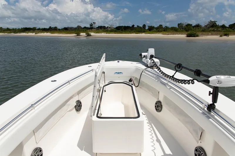  Yacht Photos Pics 2015 Invincible 36 Open Fisherman boat on calm water near a sandy shore.