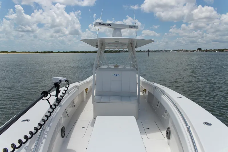  Yacht Photos Pics 2015 Invincible 36 Open Fisherman boat on calm water under a cloudy sky.